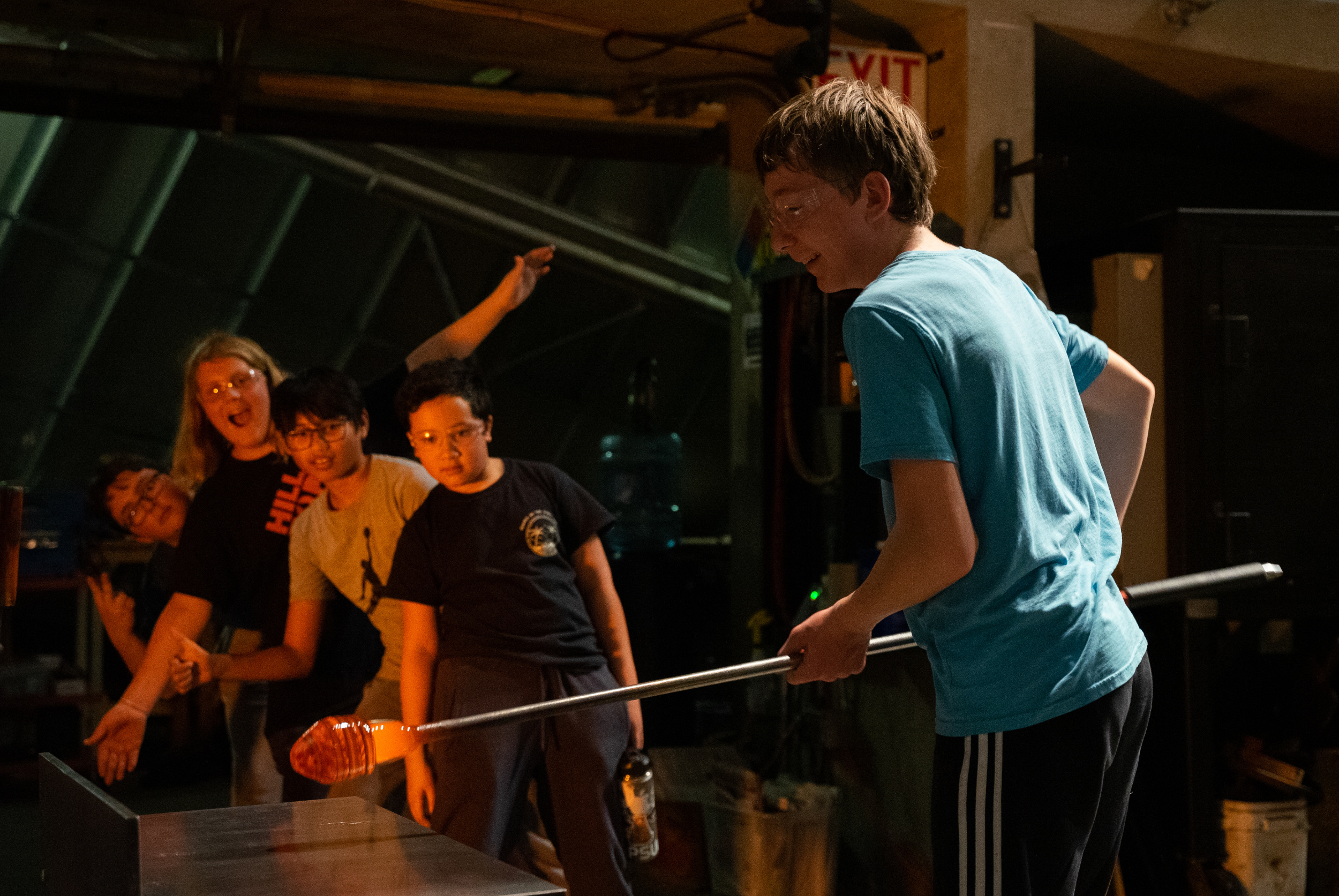 Color Photo Of Hilltop Artists Students Posing In The Hot Shop At The Museum Of Glass.